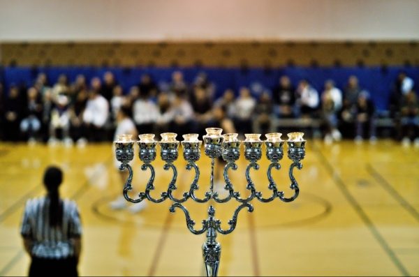 Menorah lit at the pre basketball NYHS Hannukah party.
