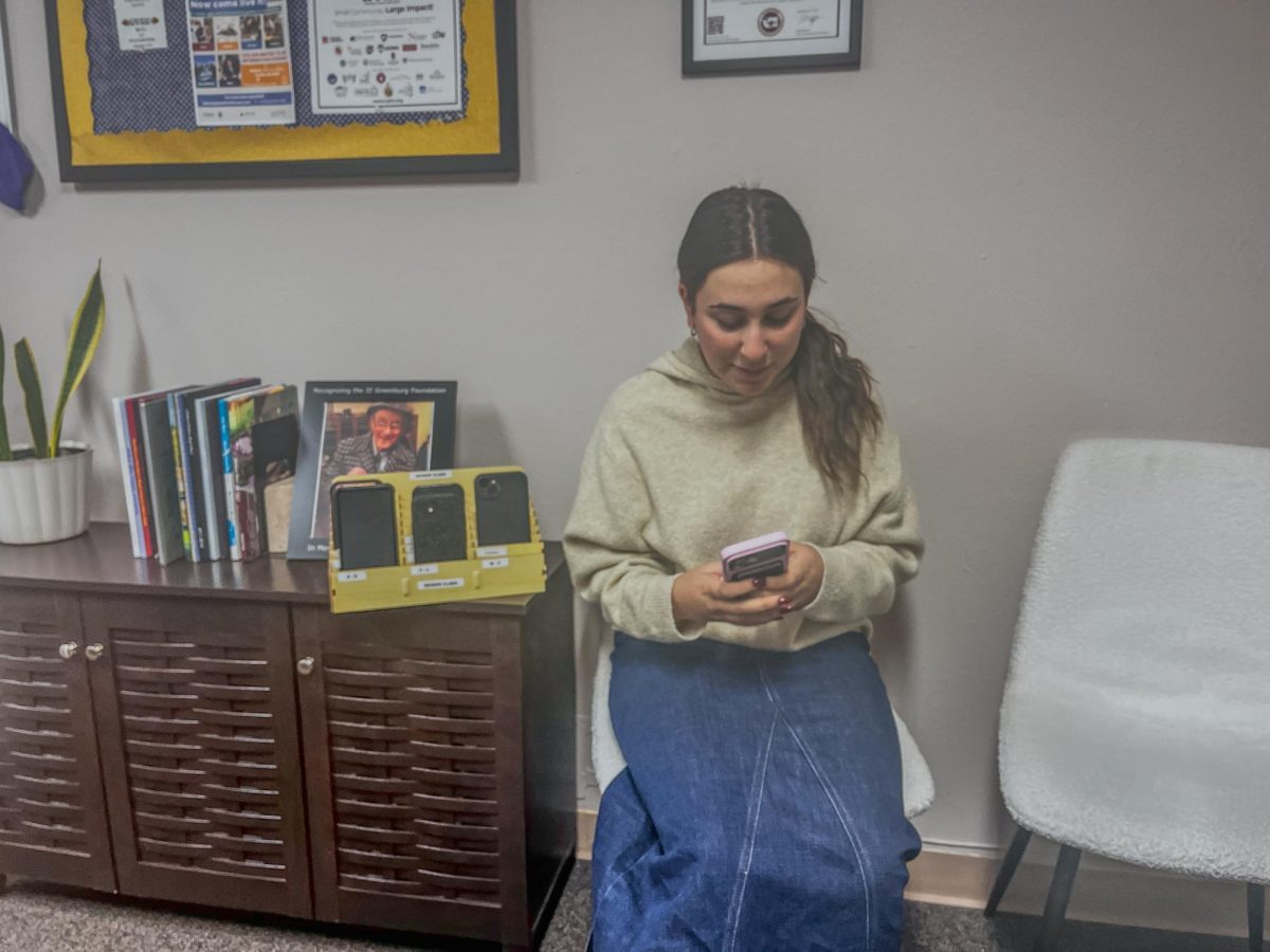 Keira Birk uses her phone in the office