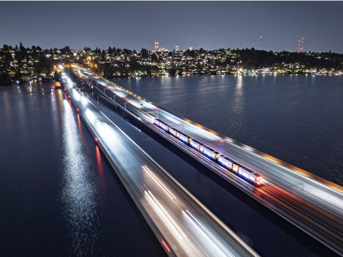 A four-car light rail vehicle (LRV) crosses the I-90 floating bridge during Crosslake livewire testing on October 8, 2025.