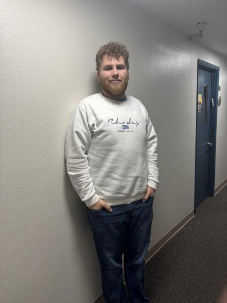 Charlie Feuer standing against a wall