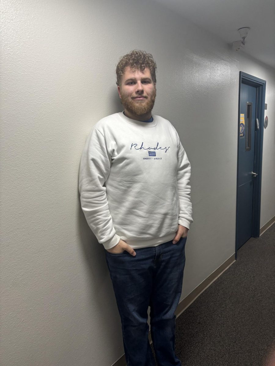 Charlie Feuer standing against a wall
