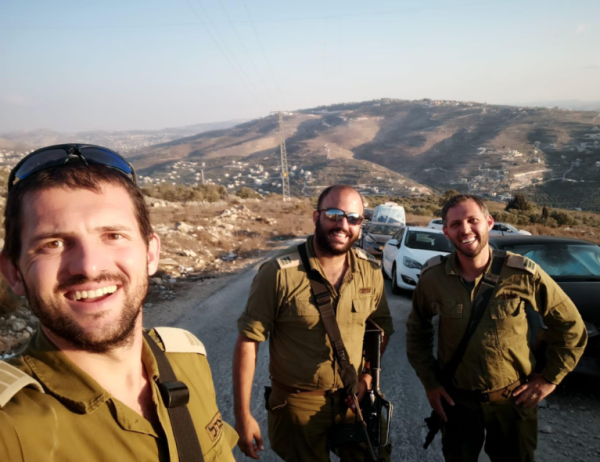 On the left is Yakov Nedlin; In the middle is Avraham Maimon; and on the right is Yonatan Himelstein, standing in front of the Samarian mountains.
